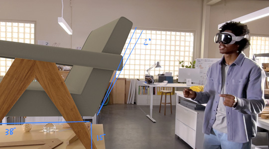 一位头戴 Apple Vision Pro 的设计师，通过手的移动对一把 3D 成像的椅子进行测量。